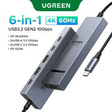 UGREEN USB-C Hub with 4K Video Ethernet and 10Gbps Data surrounded by various cables and connectors.